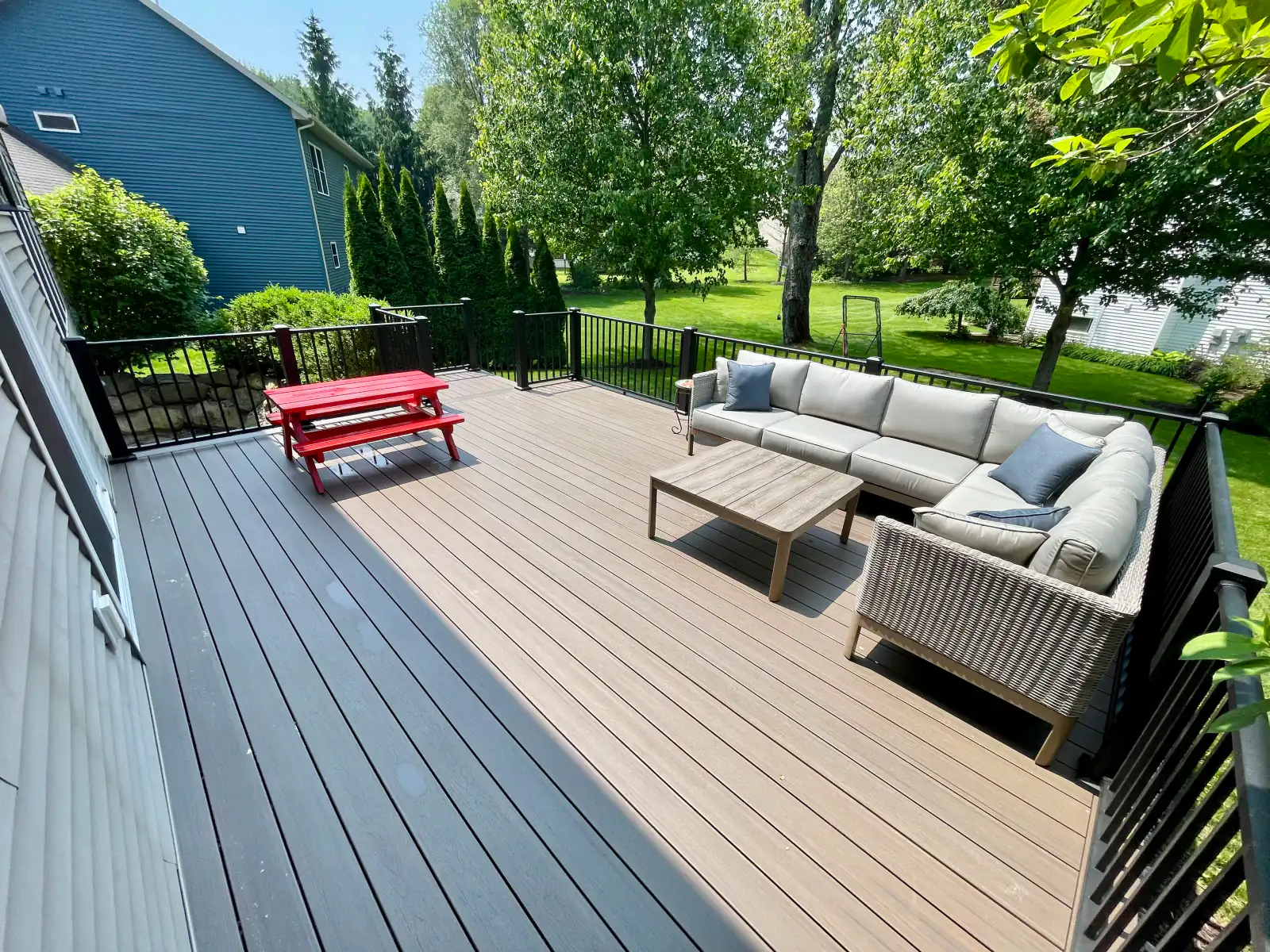 A finished outdoor deck and lounge by DNA Builders